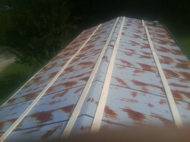 Rusted metal roof panels with new wood purlins before replacement — Storm Damage Roof Repair in Elizabethtown by Roofing Brothers