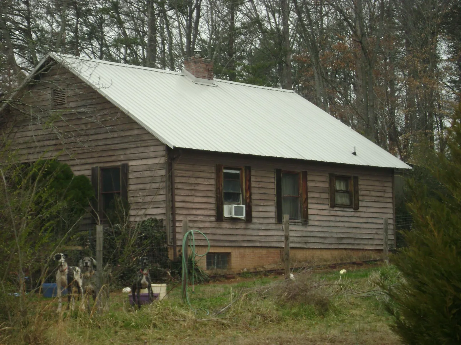 White metal roof on an old wood sided farmhouse, from a Asphalt Shingle Roof Repair job in Elizabethtown